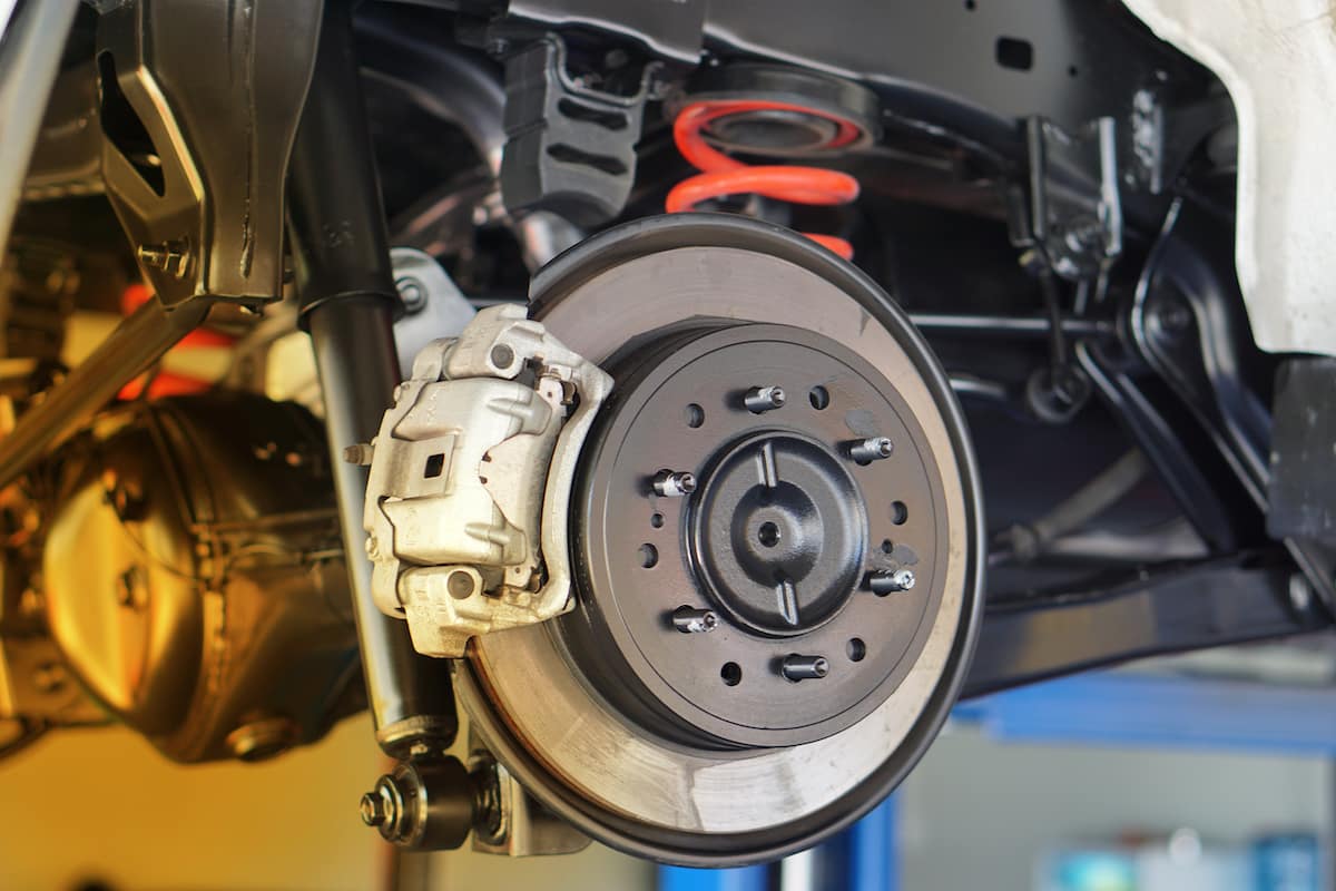 Close-up of disc brake system during mobile brake inspection and maintenance